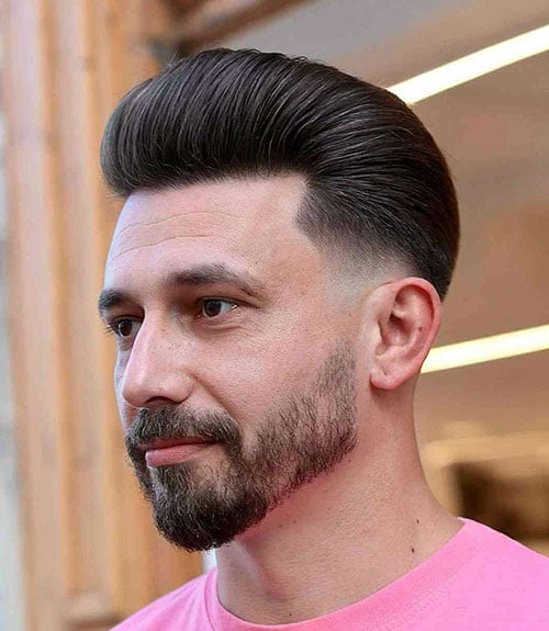 Modern Pompadour with Low Fade and Patchy Beard