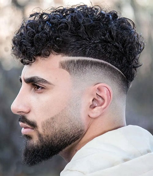 Thick Curly Top with Low Skin Fade and Part